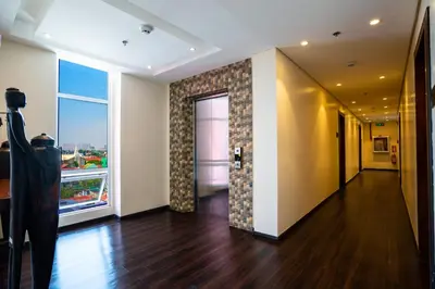 an empty room with a hallway with a large window at MySpace Hotel Comembo Taguig in Manila
