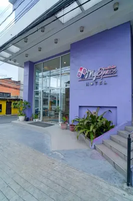 a purple building with a sign on the side of it at MySpace Hotel Comembo Taguig in Manila