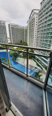 a balcony with a view of a city with tall buildings at JN Condotel The Azure Urban Resort Residences in Manila