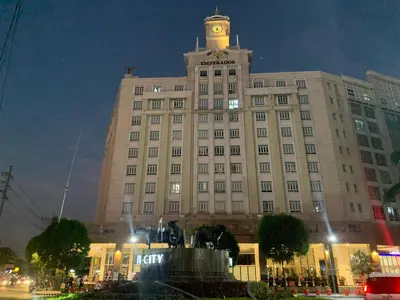 a large building with a clock tower on top of it at Pasay staycation @150Newport in Manila