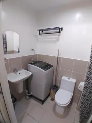 a bathroom with a toilet and a sink at SM South Residences, 1 bedroom with balcony. in Manila