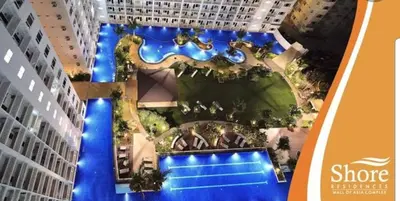 an aerial view of a building with a resort at Chic Nordic Condo Unit at Shore Residences Mall of Asia in Manila