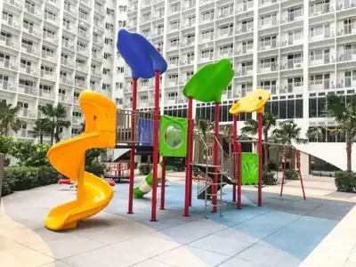 a playground in front of a large building at Chic Nordic Condo Unit at Shore Residences Mall of Asia in Manila