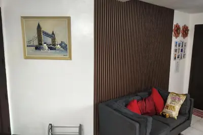 a living room with a couch and a picture on the wall at Somerset Condominium Tower 1 in Manila