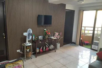 a living room with a fan on a wall at Somerset Condominium Tower 1 in Manila