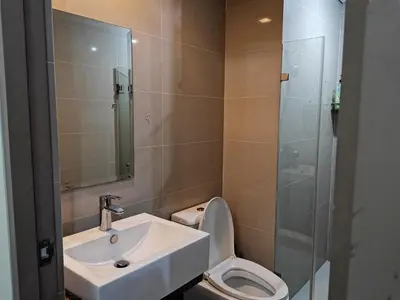 a bathroom with a toilet and a sink and a shower at palm tree villas in Manila