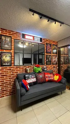 a couch in front of a brick wall at Marvel Suite Staycation -Near Doña Elena Tower in Manila