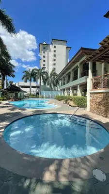 a large swimming pool in front of a building at Marvel Suite Staycation -Near Doña Elena Tower in Manila