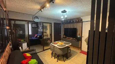 a living room with a couch and a table at Marvel Suite Staycation -Near Doña Elena Tower in Manila