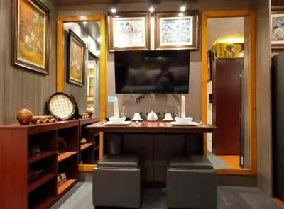 a kitchen with a bar with stools in a room at Stay Amare Green Residences Kristina in Manila