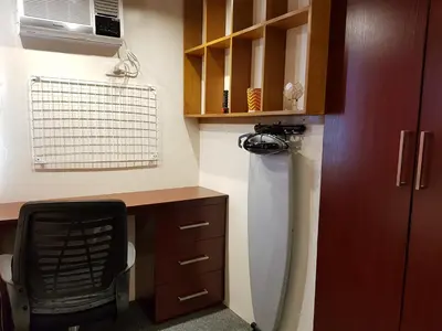 a small kitchen with a desk and a refrigerator at Stay Amare Green Residences Kristina in Manila
