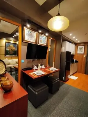 a room with a desk with a computer and a refrigerator at Stay Amare Green Residences Kristina in Manila