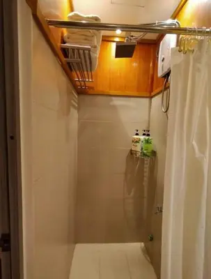 a bathroom with a shower with a shower curtain at Stay Amare Green Residences Kristina in Manila