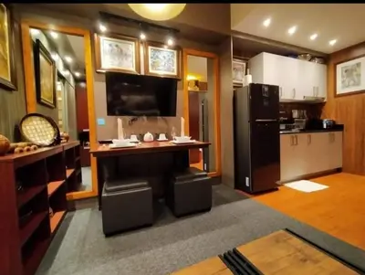 a kitchen with a counter and a refrigerator at Stay Amare Green Residences Kristina in Manila
