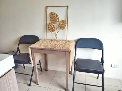 a table with two chairs and a mirror in a room at Great View@Fully Equipped Condo w/ WiFi NETFLIX @the Metro in Manila