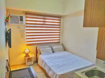 a small bedroom with a bed and a window at Great View@Fully Equipped Condo w/ WiFi NETFLIX @the Metro in Manila