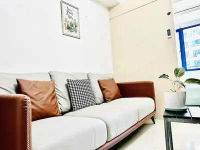 a living room with a couch with pillows on it at Sea Residences in Manila