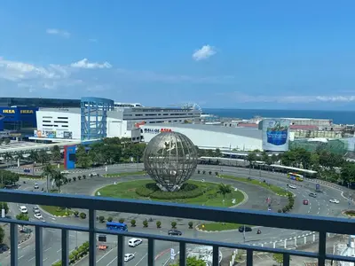 a view of a city with a large metal ball at Sea Residences in Manila