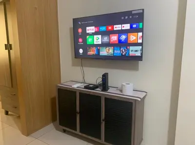 a flat screen tv hanging on a wall at Sea Residences in Manila