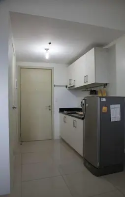 a kitchen with a refrigerator and a door in it at SMDC Jazz Residences in Manila