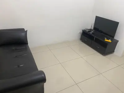 a living room with a couch and a flat screen tv at SMDC Jazz Residences in Manila