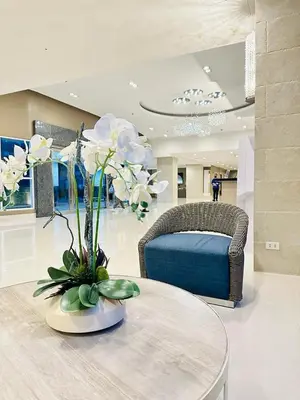a living room with a table and a couch at Sea Residences - Tino Val in Manila