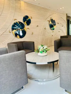 a room with a table and chairs and a wall at Sea Residences - Val Alano in Manila