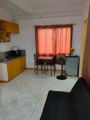 a kitchen with a table and chairs in a room at Sunmiles Condominium - 2BR unit M26 in Calamba