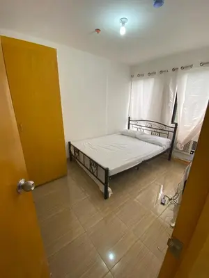 a bedroom with a bed in a room at Sunmiles Condominium - 2BR unit M26 in Calamba