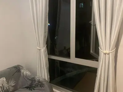 a window with white curtains in a room at Minimalist 1 Bedroom in Alabang near Molito and ATC with WiFi & Netflix m in Manila