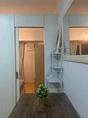 a potted plant sitting on a table in a room at Minimalist 1 Bedroom in Alabang near Molito and ATC with WiFi & Netflix m in Manila