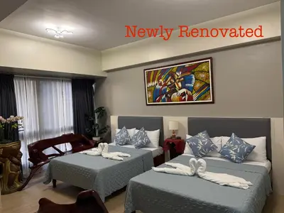 a hotel room with two beds with towels on them at Cozyvilla at 81 Newport Blvd NEWLY RENOVATED walk to NAIA T3 Marriott & Resorts World Casino & Newport Mall for 5 Pax FREE PARKING!!!! in Manila