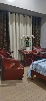 a bedroom with a bed and a table and chairs at Cozyvilla at 81 Newport Blvd NEWLY RENOVATED walk to NAIA T3 Marriott & Resorts World Casino & Newport Mall for 5 Pax FREE PARKING!!!! in Manila