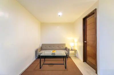 a living room with a couch and a table at Fynn Boutique Hotel in Bacoor