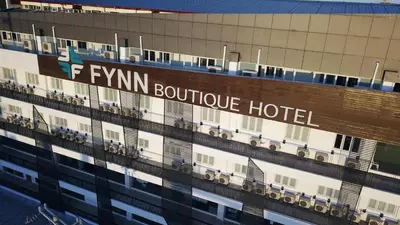 a hotel sign on the side of a building at Fynn Boutique Hotel in Bacoor