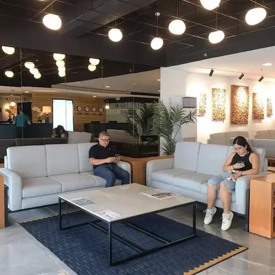 two people sitting on couches in a waiting room at Fynn Boutique Hotel in Bacoor