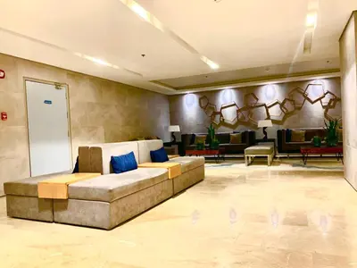 a living room with a couch in the middle at Sea Residences MOA by JO Alano New in Manila