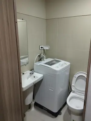 a white bathroom with a sink and a toilet at Sea Residences MOA by JO Alano New in Manila