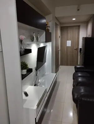 a living room with a couch and a table at Sea Residences MOA by JO Alano New in Manila