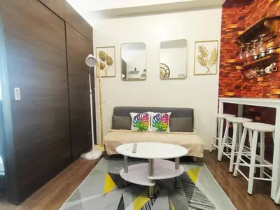 a room with a bed and a table and two stools at Fully Furnished 1 Bedroom at SMDC Air Residence with Balcony City View in Manila