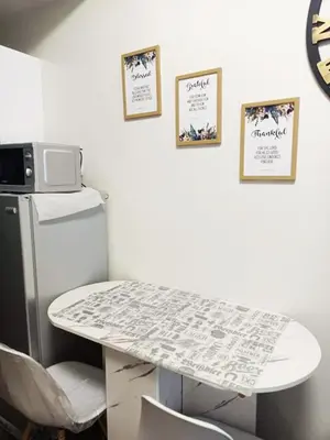 a white table in a room with a microwave at Fully Furnished 1 Bedroom at SMDC Air Residence with Balcony City View in Manila