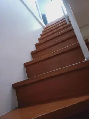 a set of stairs in a building with wooden floors at 2 Bedrooms Units Forbes Area 5th Avenue BGC Center in Manila