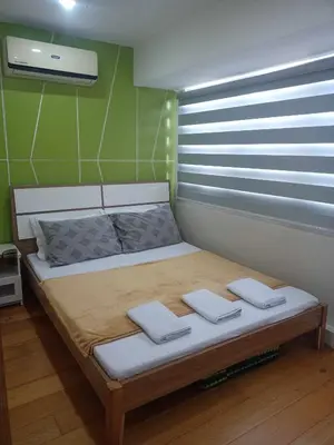 a bedroom with a bed with two towels on it at 2 Bedrooms Units Forbes Area 5th Avenue BGC Center in Manila