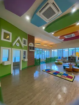 a living room with a rug on the floor at Uptown Parksuites in Manila
