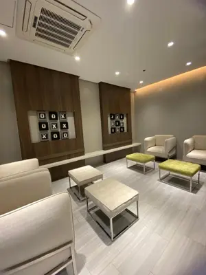 a waiting room with couches and chairs and tables at Uptown Parksuites in Manila