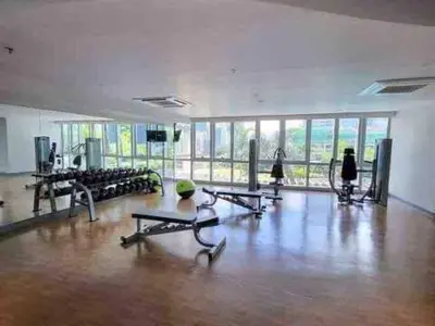 a gym with a bunch of exercise equipment in a room at Uptown Parksuites in Manila