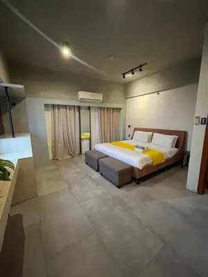 a bedroom with a large bed in a room at 2 Bedroom Service Apartment In Quezon City in Manila