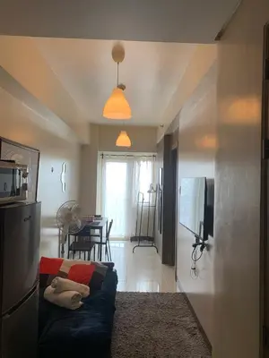a living room with a couch and a table at StayInMyCondo - 30th Condo in Pasay with Pool near Airport MOA,CCP & PICC In Pasay in Manila