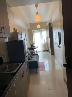 a kitchen with a couch and a living room at StayInMyCondo - 30th Condo in Pasay with Pool near Airport MOA,CCP & PICC In Pasay in Manila