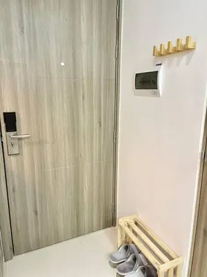 a bathroom with a door and a pair of shoes at 1BR Suite near Megamall, Boni & Shaw MRT Station in Manila